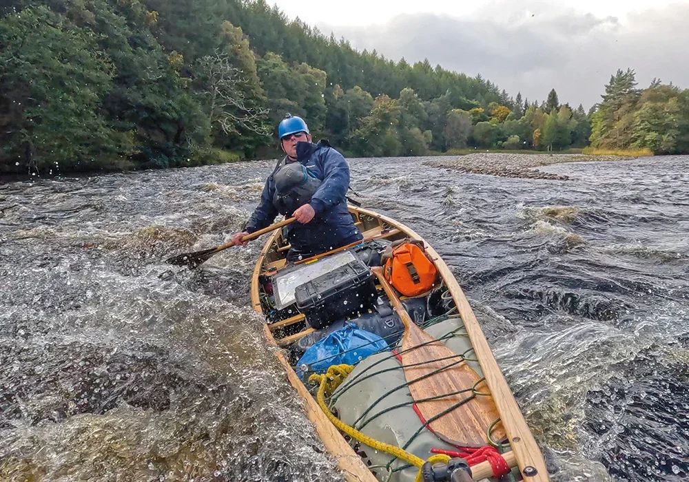 Broadland 15 Composite Filled with Gear in Rough Water Paddled by Ray Goodwin MBE